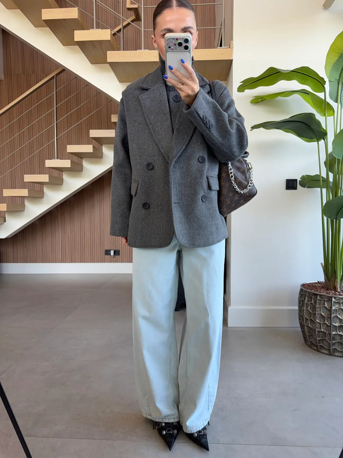Double-breasted wool-blend overcoat paired with a matching gray turtleneck top
