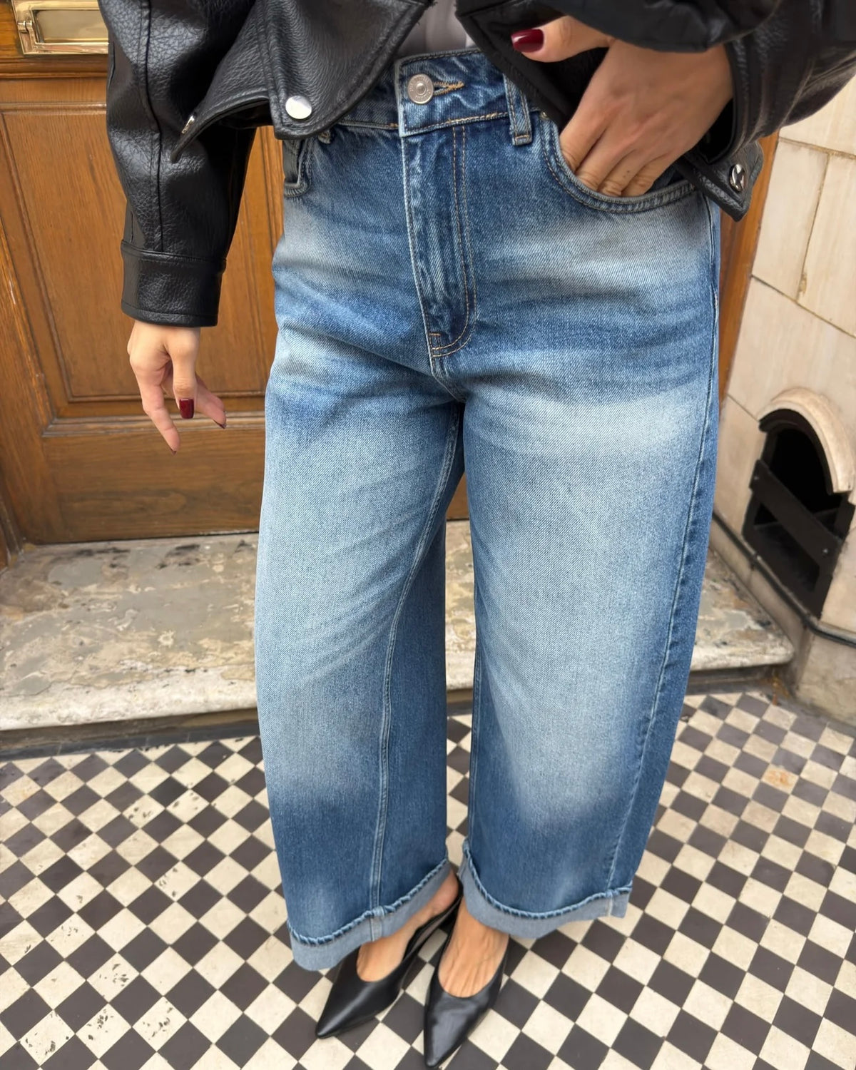 Wide-leg blue jeans with a faded wash and folded hems