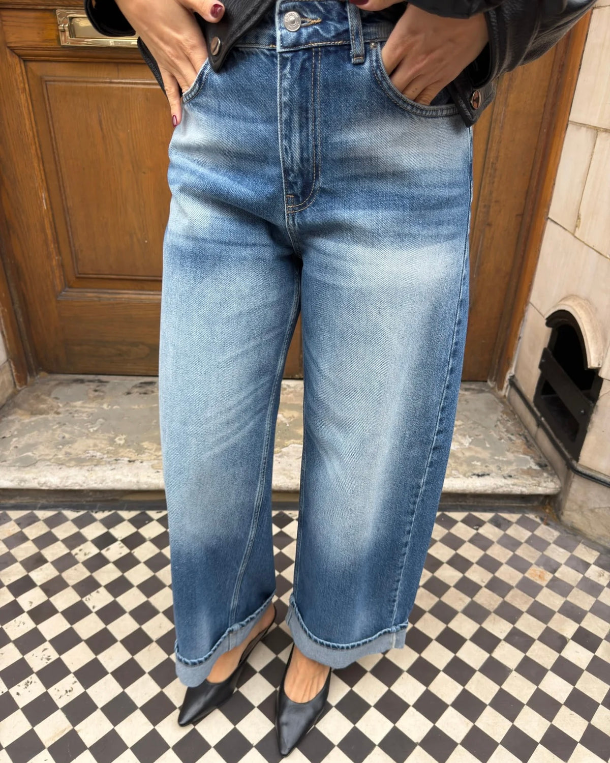 Wide-leg blue jeans with a faded wash and folded hems