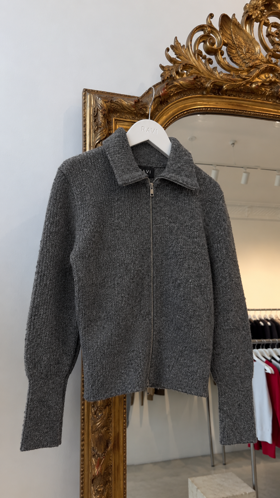 Zip-up cardigan with a wide collar and fitted waist.