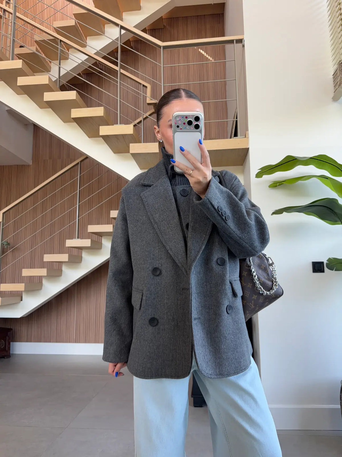 Double-breasted wool-blend overcoat paired with a matching gray turtleneck top