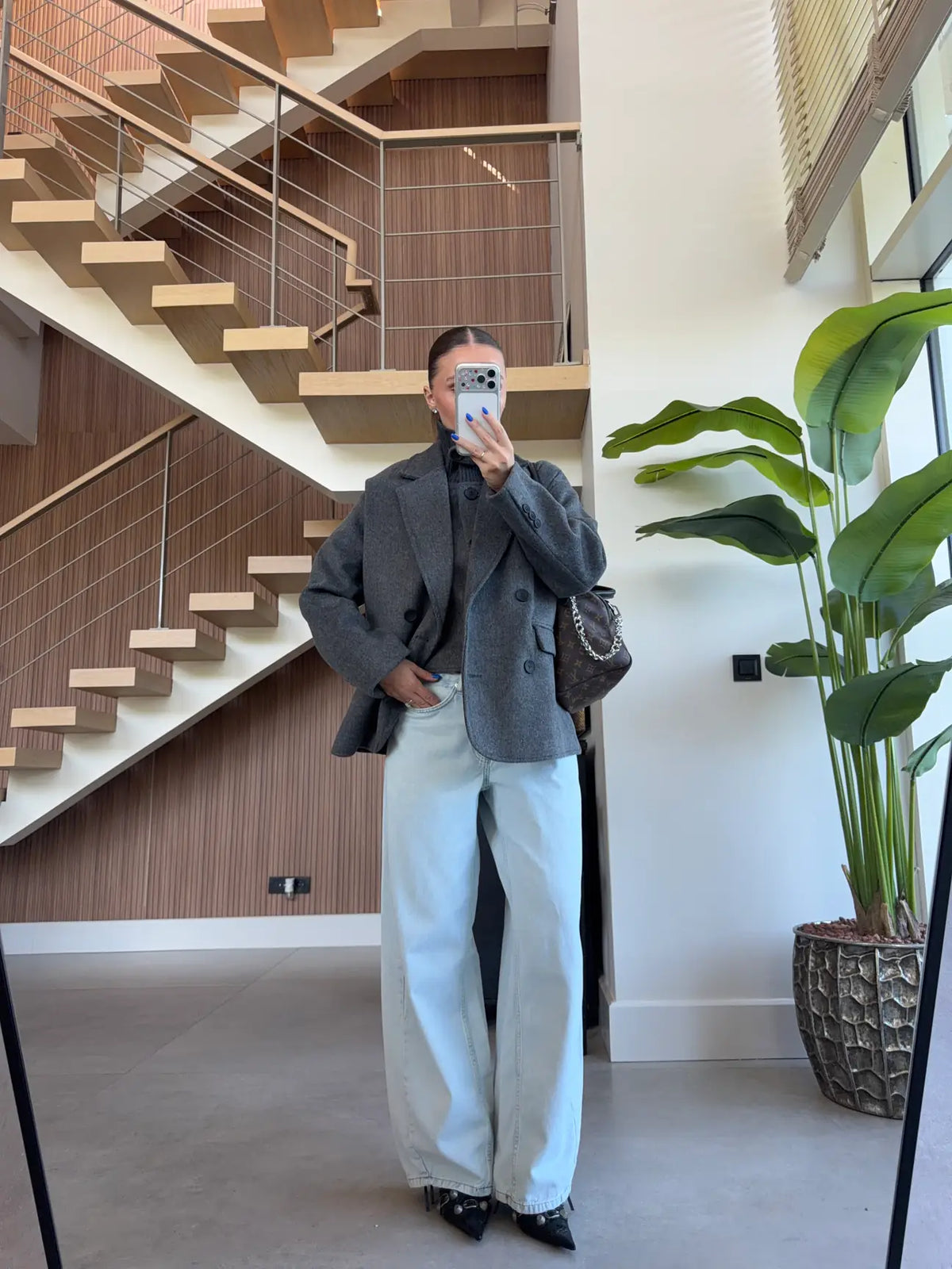 Double-breasted wool-blend overcoat paired with a matching gray turtleneck top