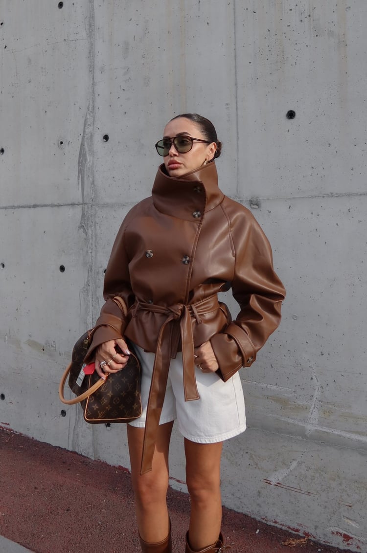 Brown faux leather jacket with its dramatic high funnel collar and matching tie belt.