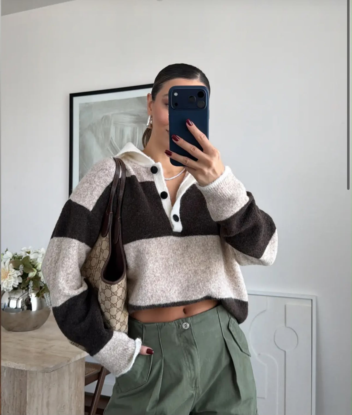 Brown and beige colorblock striped knit polo sweater.