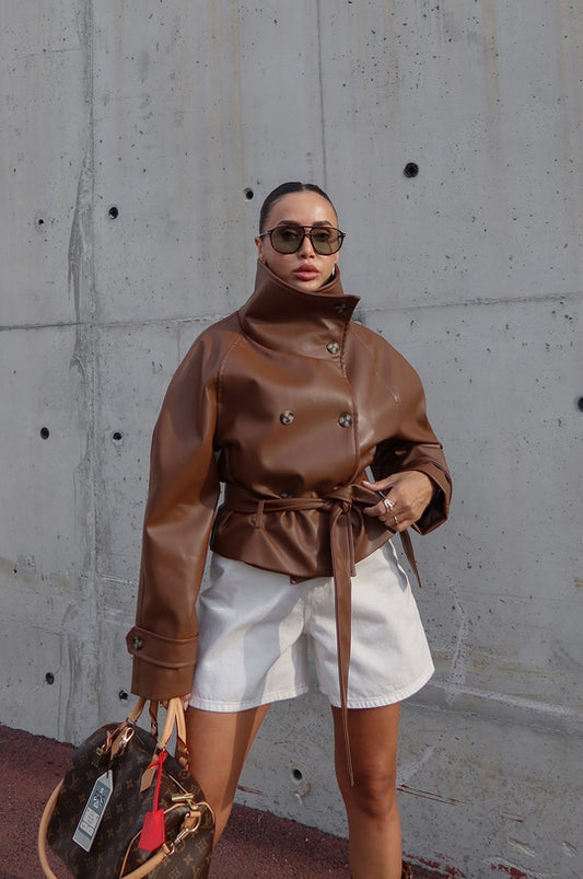 Brown faux leather jacket with its dramatic high funnel collar and matching tie belt.