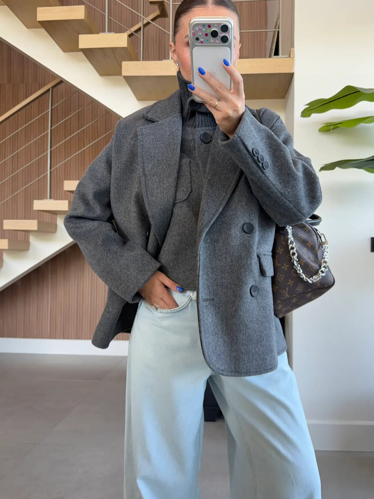 Double-breasted wool-blend overcoat paired with a matching gray turtleneck top