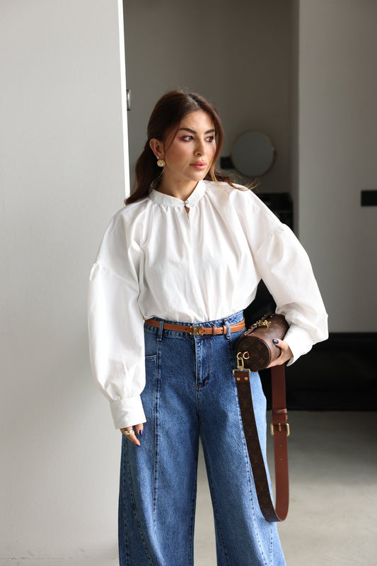 Oversize blouse with pearl buttons on the collar