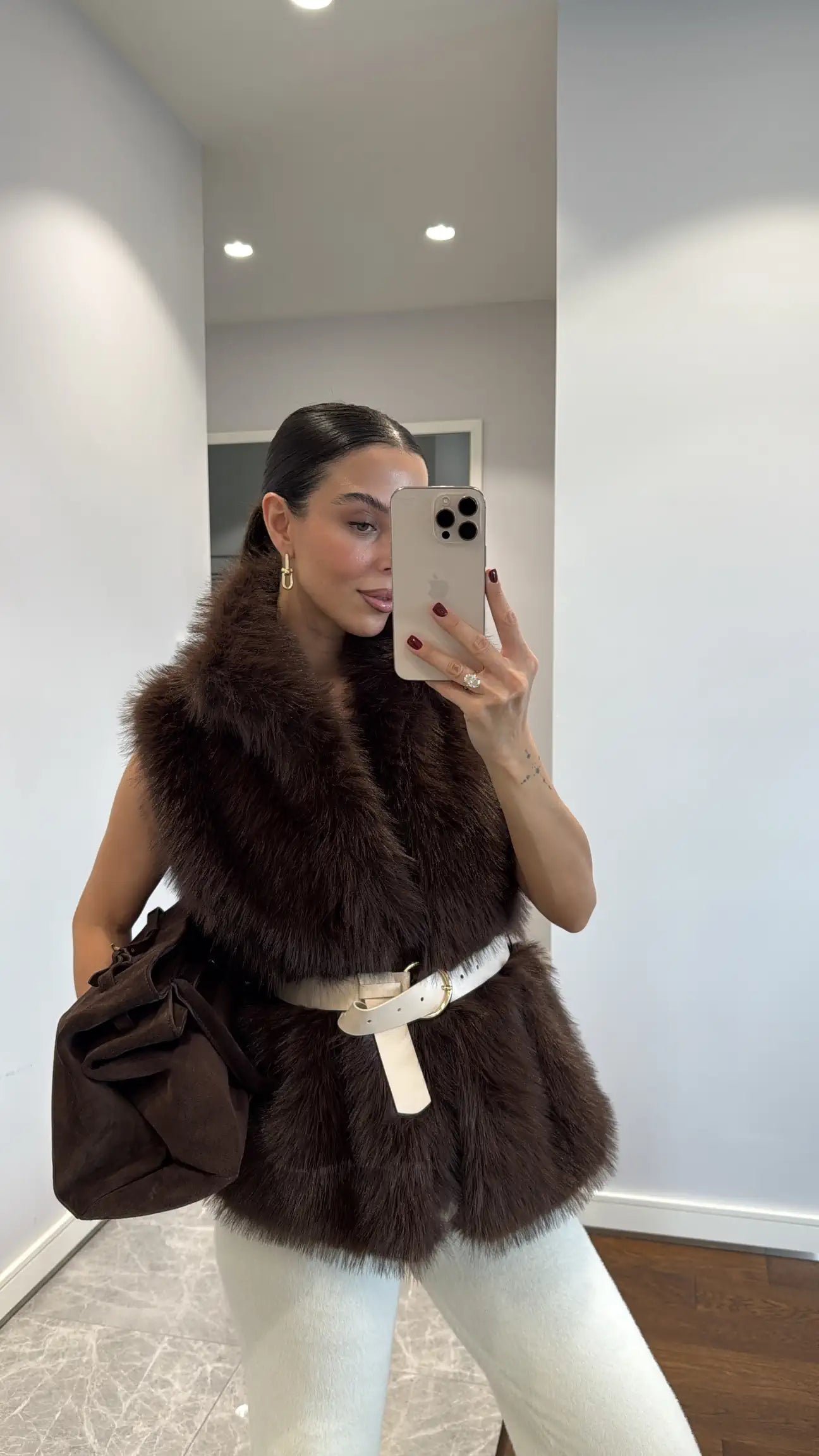 Fur vest with belts