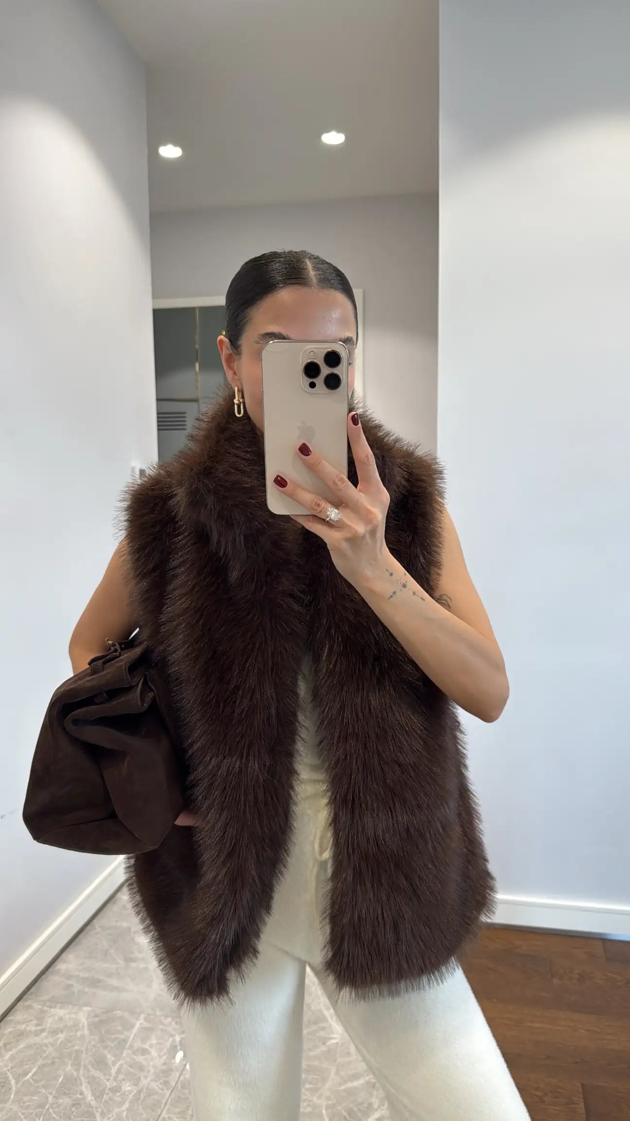 Fur vest with belts