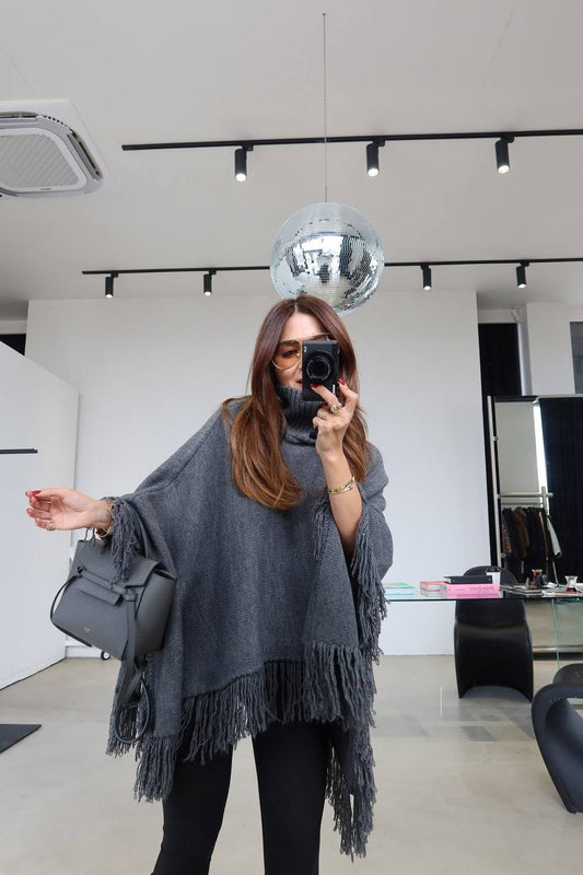 Turtleneck poncho with tassel hem